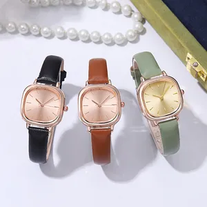 Three quartz watches in black, brown, and green leather straps on velvet background