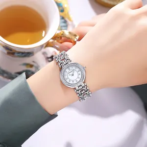 Elegant silver women's watch featuring a mother of pearl dial and rhinestone chain bracelet