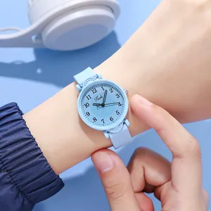 Close-up of light blue quartz watch with silicone strap and Arabic numeral dial on wrist