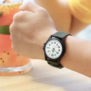 Men's quartz watch with green nylon strap shown in a casual lifestyle setting
