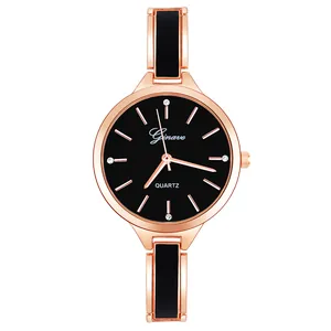 Detail of rose gold quartz watch featuring a black dial and elegant rhinestone markers