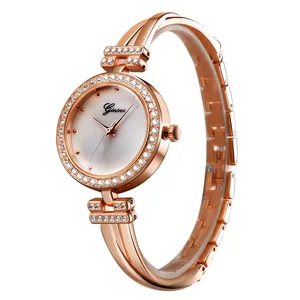 Detail of rose gold bracelet watch with rhinestone bezel and polished metal finish