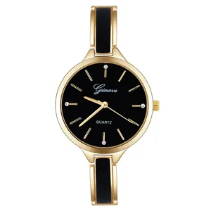 Close-up of a women's gold quartz watch with a black dial and enamel link bracelet