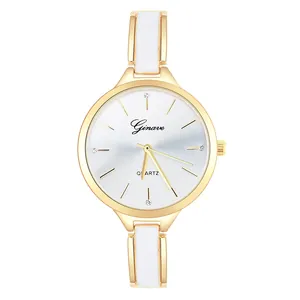 Macro detail of gold quartz watch featuring sparkling rhinestones on a sunray dial