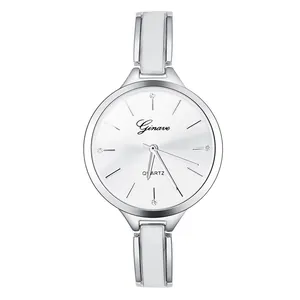 Macro shot of silver quartz watch dial with diamond markers and sleek white metal strap