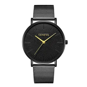 Detail of minimalist black mesh strap watch with sandblasted dial and golden indices