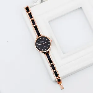 Elegant rose gold and black chain link quartz watch for women on decorative background