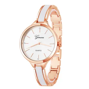 Close-up of rose gold quartz watch with white enamel inlay bracelet and round dial