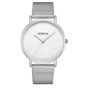 Macro shot of silver mesh metal watch band with minimalist white dial on white background