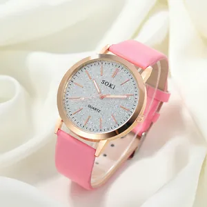 Close-up of stylish pink leather quartz watch on elegant white silk background