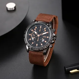 SOKI men's casual quartz watch with black alloy case and brown nylon strap on desk
