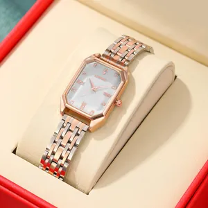 Close-up of rectangular quartz watch with bicolor rose gold strap in a red gift box