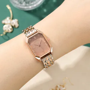 Close-up of elegant octagonal rose gold watch with sparkling dial and metal strap