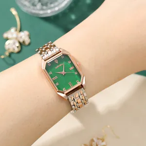 Detailed shot of a vintage women's quartz watch with a green dial and bicolor metal strap