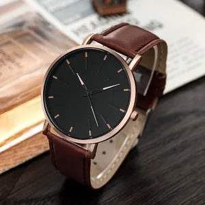 Detail of rose gold watch with black dial and premium brown leather strap on wood