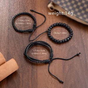 Three-piece black beaded and braided leather bracelet set for men on vintage wooden background