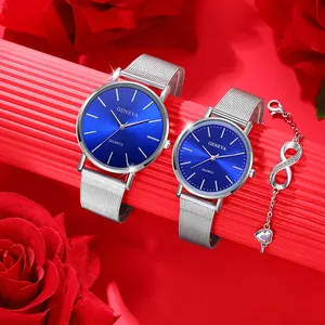 Detail of couple quartz watches with blue dials, mesh bands and infinity heart bracelet