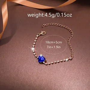 Elegant rose gold heart bracelet with blue crystal and white rhinestones on silk