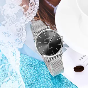 Geneva quartz watch with silver mesh band and dark grey sunburst dial on aesthetic background