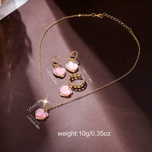 Pink heart-shaped necklace, ring, and earrings set with gold finish and crystal accents