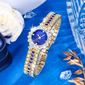 Luxury women's quartz watch with starry blue dial and gold-tone metal band encrusted in zircons