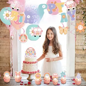 Detail of Groovy retro hippie party set with daisy banners, balloons, and cake toppers