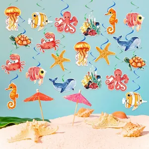 Ocean themed party decorations featuring hanging swirl ornaments with sea animal cutouts