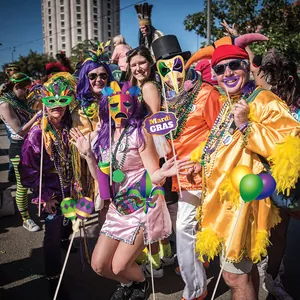 Colorful Mardi Gras photo booth props with masks and feathers for carnival party fun