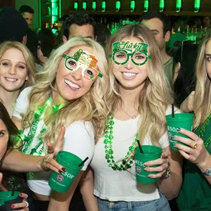 Green St. Patrick's Day party paper glasses with Lucky and Shamrock themed designs