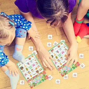 Kids playing Easter Bingo game cards featuring colorful eggs and bunnies on wooden floor