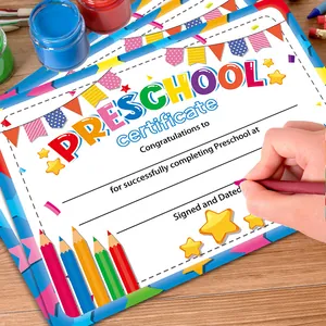 Colorful Preschool graduation certificate on wooden desk with art supplies background