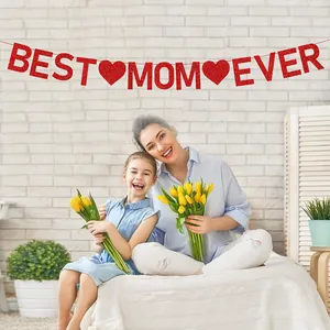 Glittery red Best Mom Ever banner for Mother's Day party decoration in home setting