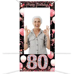 Close-up of rose gold 80th birthday photo booth frame with crown and balloon motifs