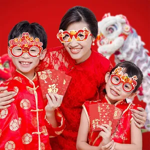 Festliche chinesische Neujahrs-Papierbrillen und rote Umschläge für Neujahrsfeier 2025