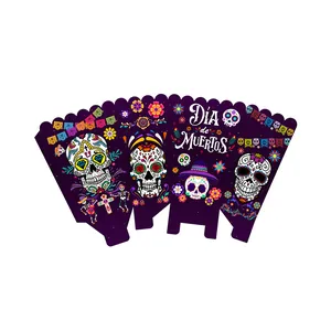 Detail of Day of the Dead popcorn boxes with sugar skulls and marigolds on deep purple paper