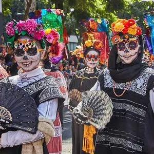 Day of the Dead paper glasses featuring sugar skull and marigold festival designs