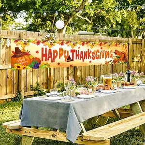 Outdoor Thanksgiving banner with pumpkins and maple leaves on a rustic wooden fence