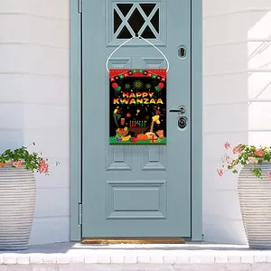 Outdoor Happy Kwanzaa garden flag with Kinara and drums hanging on a blue front door