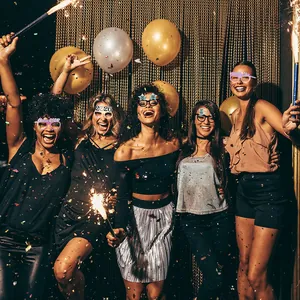 Cheerful diverse models wearing glittery 2026 Happy New Year party eyewear with confetti