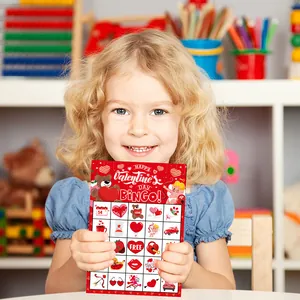 Girl holding a red Valentine's Day Bingo game card with hearts and Cupid designs