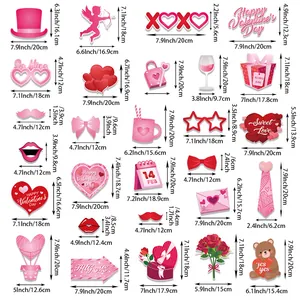 Pink Valentine's Day photo booth props set with heart shapes and festive party decorations