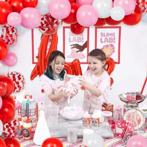 DIY slime making kit featuring liquid glue, glitter, and festive party decorations