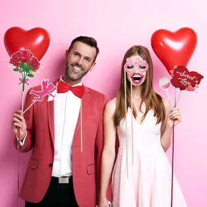 Valentine's Day photo booth props set with pink hearts and Cupid designs for party decor