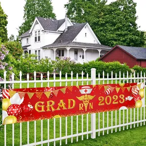 Nurse graduation party banner with red background and golden GRAD RN 2023 text