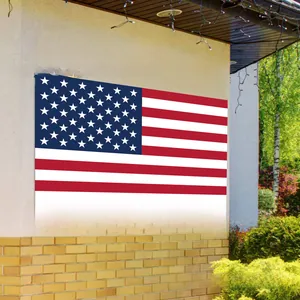 Outdoor Independence Day banner with stars and stripes hanging on a modern brick wall