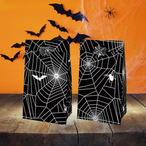 Halloween gift bags with spider web pattern on vintage wooden table for party decor
