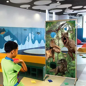 Dinosaur themed bean bag toss game banner with scoring holes and metal stand for kids party