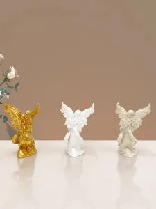 Detailed view of angel wing textures on decorative resin figurines in three elegant colors
