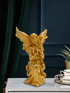 Detailed view of a golden praying angel statue with intricate feather textures