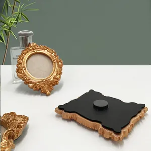 Close-up of vintage baroque style gold mini resin frames with magnetic backing